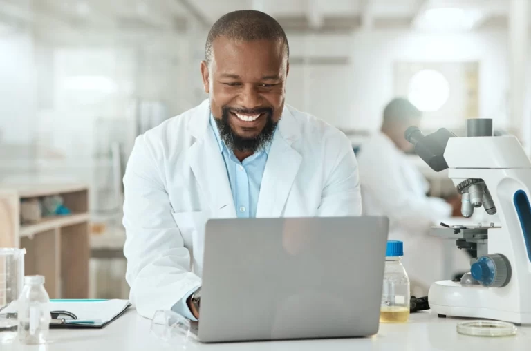 shot-of-a-handsome-mature-scientist-sitting-alone-in-his-laboratory-and-using-his-laptop